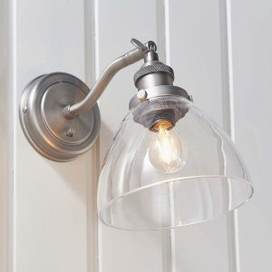 Hansen switched industrial wall light in brushed silver on room wall