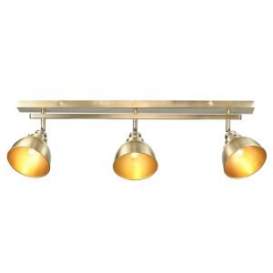 Wyatt 3 lamp industrial spot light bar in antique brass on white background lit