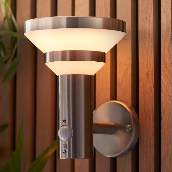 Halton modern solar outdoor wall light in brushed stainless steel on garden fence lit