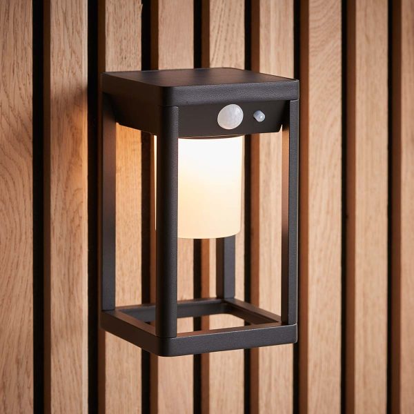 Hallam solar PIR outdoor wall lantern in black on exterior fence lit