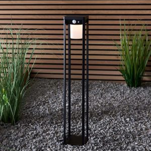 Hallam modern 60cm solar outdoor post light in textured black in garden setting lit