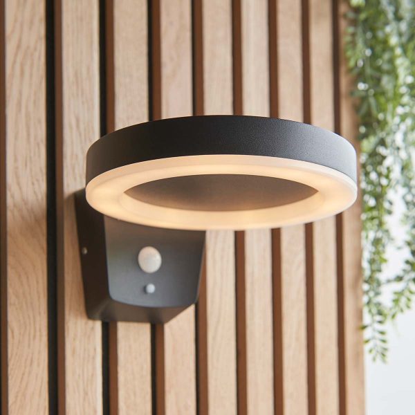 Ebro contemporary solar PIR outdoor wall light in black on garden fence