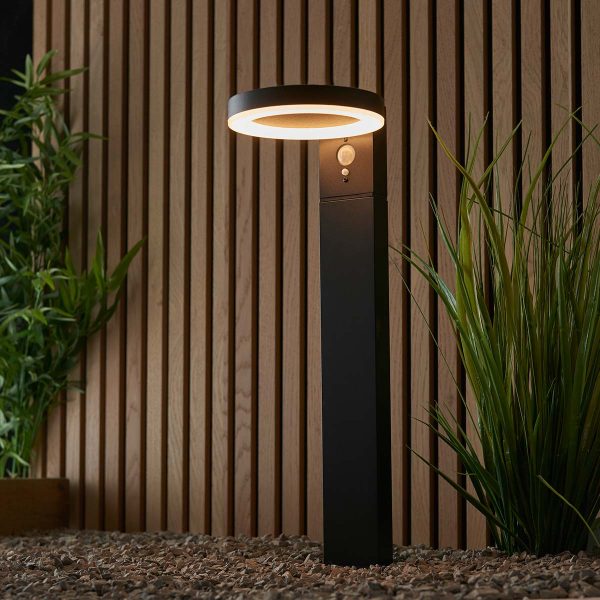 Ebro contemporary solar PIR outdoor post light in black shown in garden setting