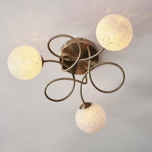 Delos 3 light antique brass semi flush ceiling light on room ceiling lit