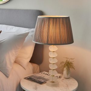 Annabelle frosted crystal table lamp in brushed gold with charcoal silk shade on bedside table