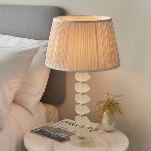 Annabelle frosted crystal table lamp in brushed gold with oyster silk shade on bedside table