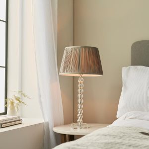 Adelie stacked clear crystal table lamp with charcoal silk shade on bedside table
