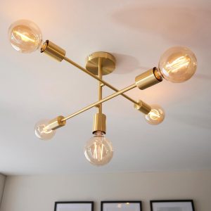 Studio 5 light industrial semi flush ceiling light in brushed brass on room ceiling lit