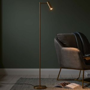 Modern LED dedicated floor reading lamp in warm brass in sitting room setting
