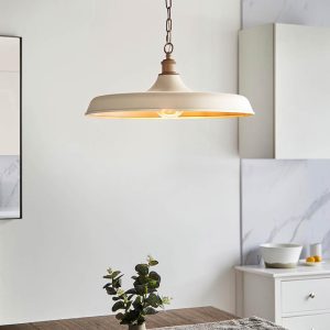 Classic matt warm white kitchen pendant with satin brass, shown over a kitchen dining table.