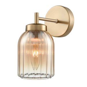 Franklite Caligo single aged brass wall light with amber ribbed glass shade on white background.