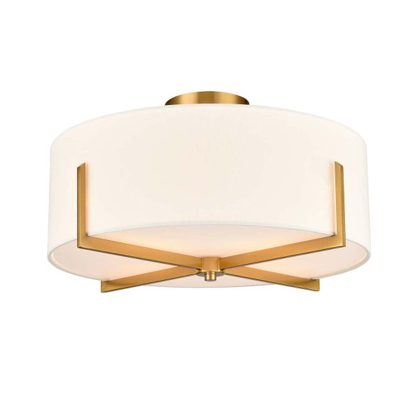 Clifton 4 light aged brass flush ceiling light with textured cream fabric shade, shown lit on white background.