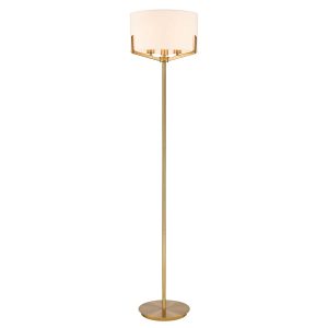 Franklite Clifton 3 light aged brass floor lamp with cream fabric shade, on white background, lit.