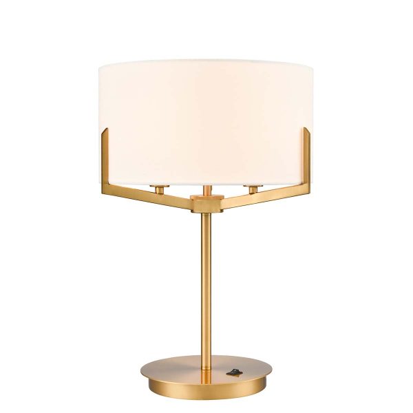 Franklite Clifton 3 light aged brass table lamp with cream fabric shade, on white background, lit.