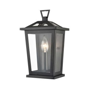Dusk 1 light small exterior wall lantern in matt black with clear glass on white background.