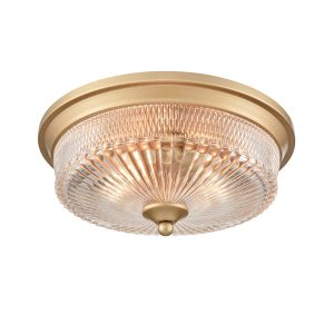 Franklite Emerson 2 light flush ceiling light in painted gold with clear ribbed glass shade, on white background, lit.