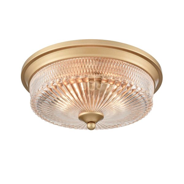 Emerson 2 light flush ceiling light in painted gold with clear ribbed glass shade, on white background, lit.