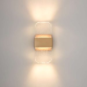 Franklite Frost LED small IP54 wall light in aged brass with cast rippled glass, on grey background.