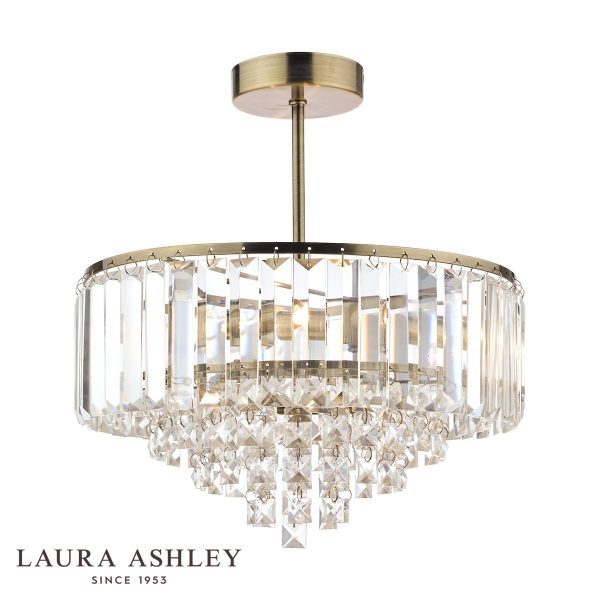 Laura Ashley Vienna 3 light crystal semi flush ceiling light in antique brass on white background, lit.
