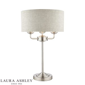 Sorrento 3 light table lamp in satin nickel with natural linen shade on white background, lit.
