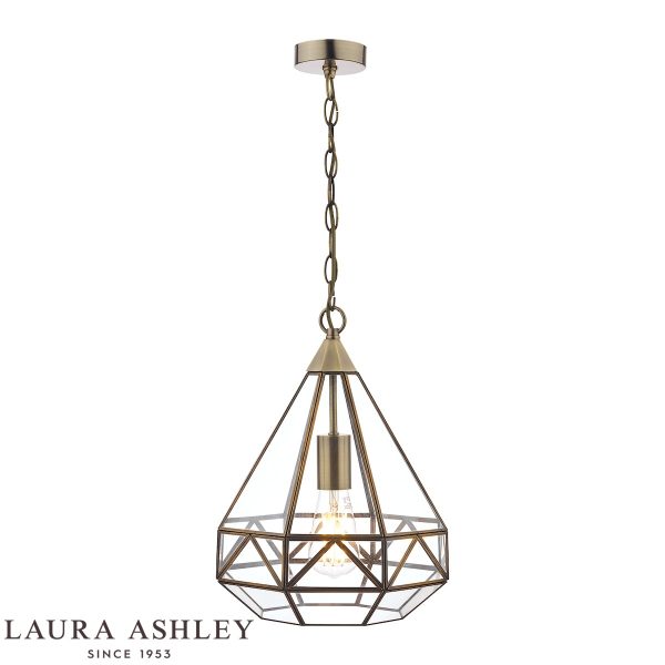 Zaria pendant lantern in antique brass finish with clear glass panels, on white background, lit.
