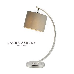 Laura Ashley Noah modern small table lamp in polished nickel on white background, lit.