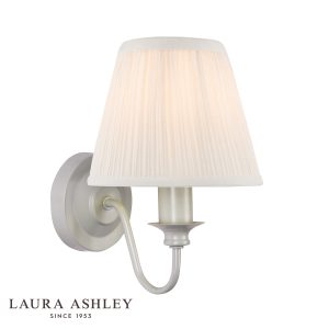 Laura Ashley Ellis switched wall light in satin grey finish with ivory shade on white background, lit.