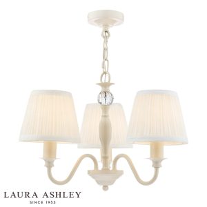 Laura Ashley Ellis 3 light chandelier in satin ivory finish with ivory shades, full height on white background, lit.