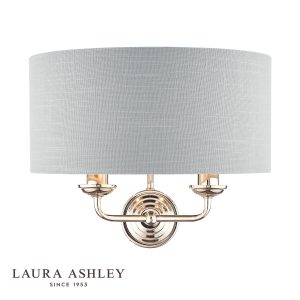 Sorrento 2 light wall light in polished nickel finish with silver linen shade by Laura Ashley, on white background, lit.