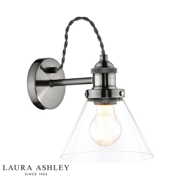 Laura Ashley Isaac single wall light in satin nickel finish on white background, lit.