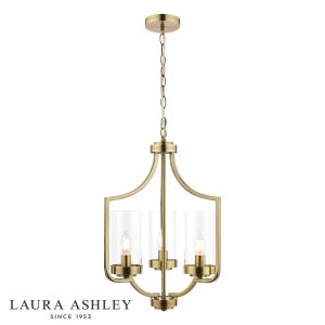 The Laura Ashley Joseph 3 light chandelier in antique brass with glass shades, on white background, lit.