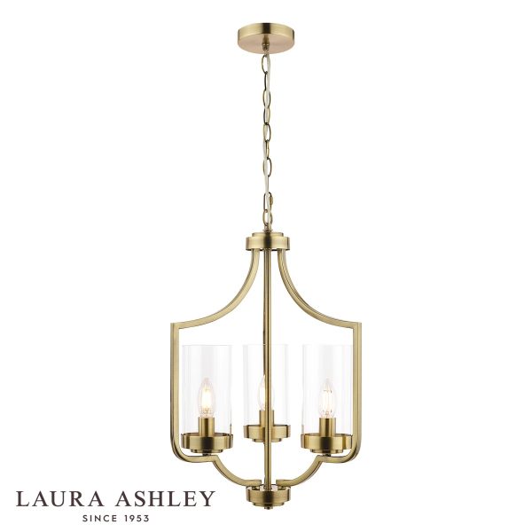 The Laura Ashley Joseph 3 light chandelier in antique brass with glass shades, on white background, lit.