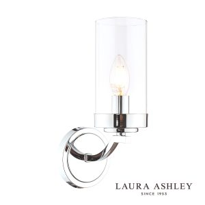 The Laura Ashley Joseph single wall light in polished chrome with glass shade, on white background, lit.