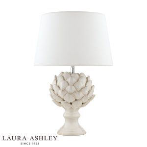 Laura Ashley cream ceramic Artichoke table lamp with ivory linen shade, on white background.