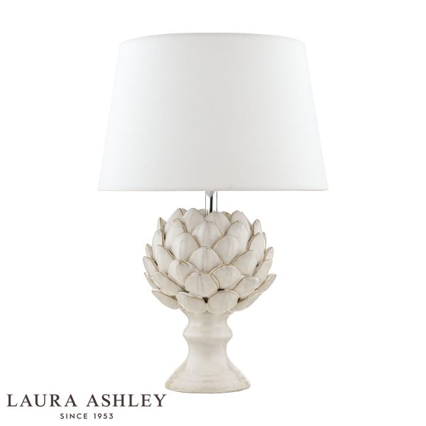 Laura Ashley cream ceramic Artichoke table lamp with ivory linen shade, on white background.