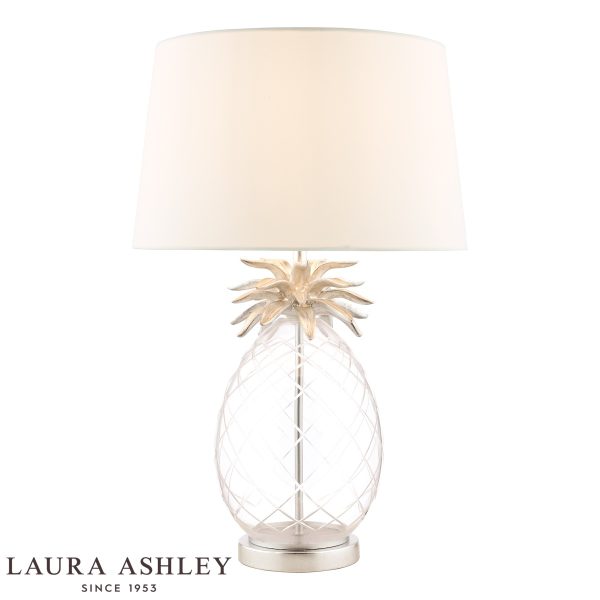 Laura Ashley Pineapple table lamp in clear cut glass on white background, lit.