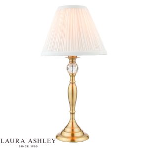 Laura Ashley Ellis table lamp in antique brass finish with ivory shade on white background.