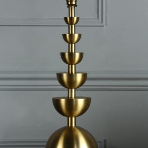 Laura Ashley Eleonore table lamp base only in aged brass, shown without shade on sideboard.
