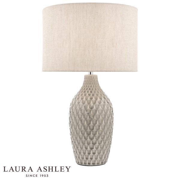 Heathfield grey ceramic table lamp with natural linen shade and chrome metalwork by Laura Ashley, shown lit on white background.