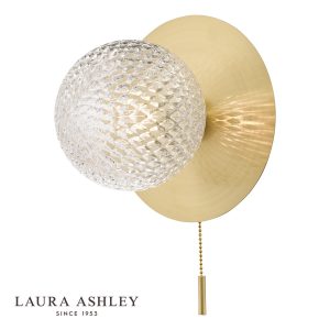 Prague switched bathroom wall light in satin brass finish on white background, lit.