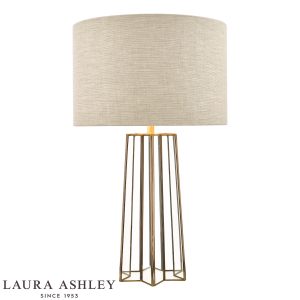 Laura Ashley Star table lamp in antique brass on white background, lit.