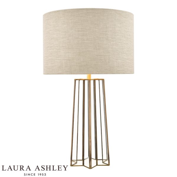 Laura Ashley Star table lamp in antique brass on white background, lit.