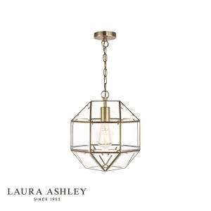 Blackwell pendant lantern in antique brass finish with clear glass panels, on white background, lit.