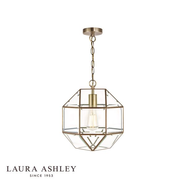 Blackwell pendant lantern in antique brass finish with clear glass panels, on white background, lit.