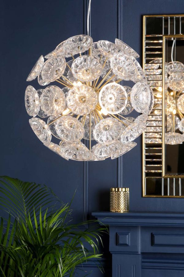 Laura Ashley Elwick 6 light pendant with textured glass in matt antique brass, shown in room setting, lit.