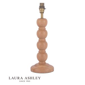 Maria oak wood candlestick table lamp with antique brass metalwork by Laura Ashley, shown without shade on white background.
