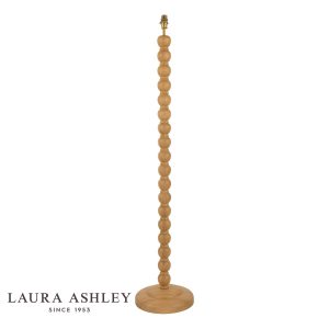 Maria oak wood candlestick floor lamp with antique brass metalwork by Laura Ashley, shown without shade on white background.