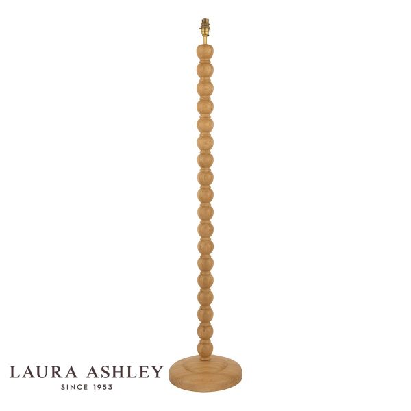 Maria oak wood candlestick floor lamp with antique brass metalwork by Laura Ashley, shown without shade on white background.