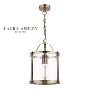 Harrington 1 light hanging lantern in antique brass finish with clear glass by Laura Ashley, on white background, lit.
