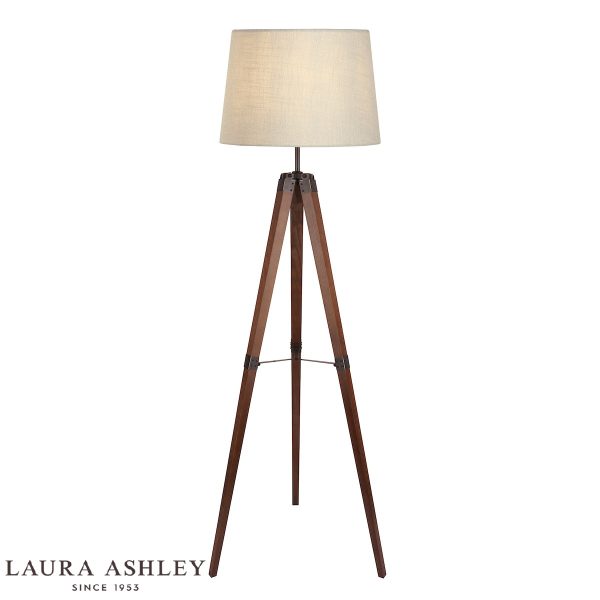 Laura Ashley Burdale tripod floor lamp in dark wood, shown lit on white background, with shade.